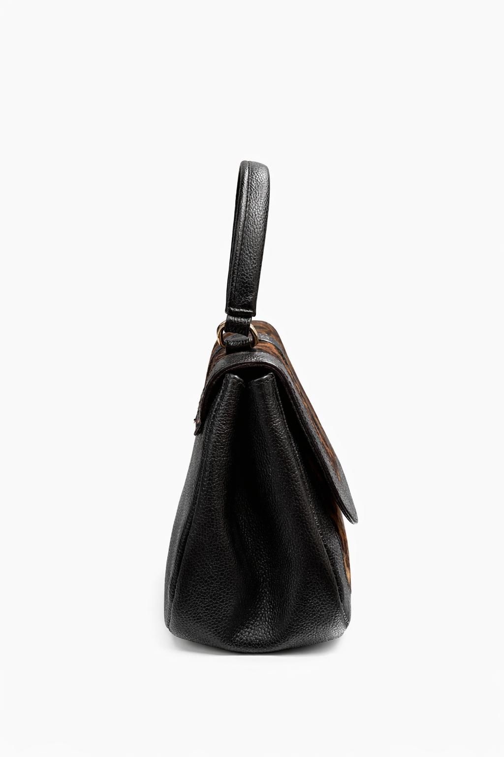 Bolso de mano en cuero pasiflora color negro animal print